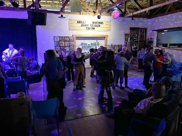A crowd dancing to live music inside Mary's Place