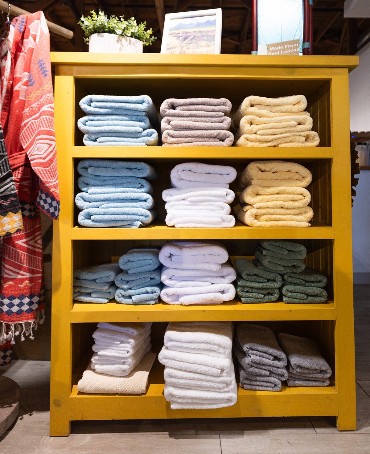 Shelves of folded towels and throws